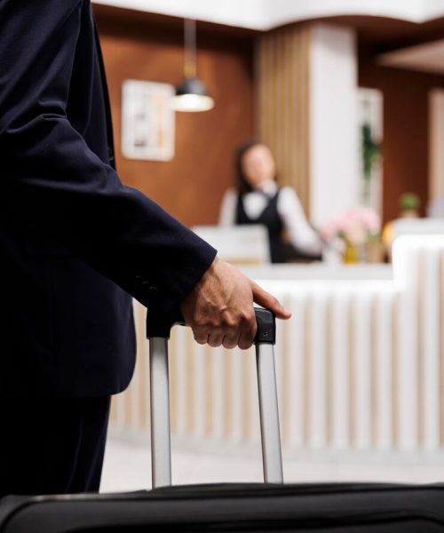 hotel-guest-entering-reception-with-luggage-travelling-abroad-attend-important-business-meetings-entrepreneur-approaching-front-desk-check-booking-accommodation-close-up_482257-65305
